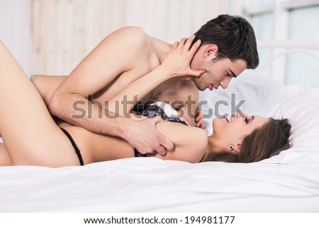 Young passionate couple making love in bed