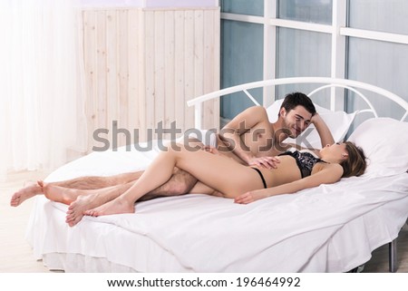 Young love couple in bed, romantic scene in bedroom