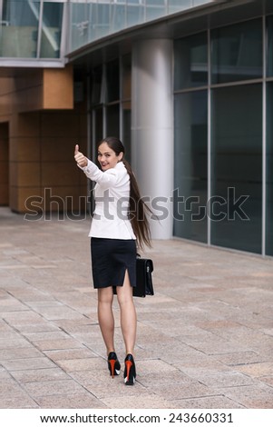 Beautiful businesswoman walk away and show thumb up
