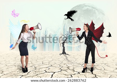 Portrait of angel and devil girls with megaphone in desert