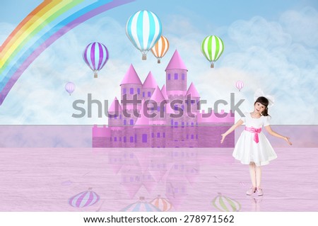 Little girl in a princess dress in front of a pink fairy castle