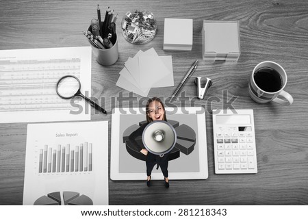 Woman with megaphone on office table. Desk office financial accounting graphs analysis
