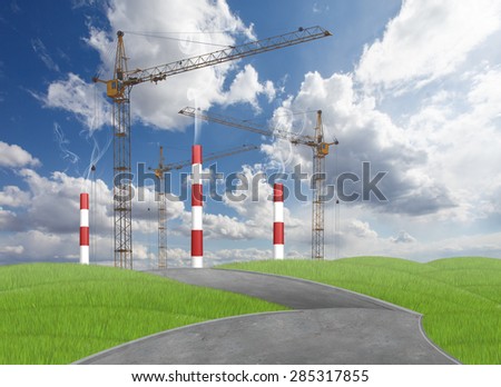 Industrial pipes and cranes with grass and road in front of it