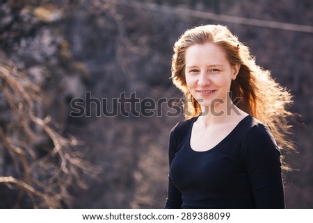 Outdoors portrait of beautiful woman with red hair without makeup