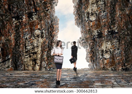 Business person looking at the end of the cave