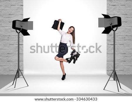 Business woman in photo studio room with white cloth and spotlights