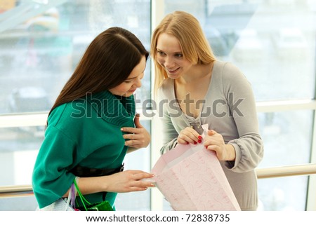 Young women in store looking in bag