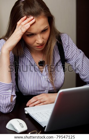 A stressed business woman in front of laptop