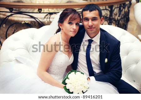 Newlyweds sitting on the sofa in the hall
