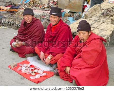 LHASA, TIBET-NOVEMBER 11: monks collecting money in Barkhor Street. The ancient street is a symbol of Lhasa and a must see place for visitors. November 11, 2004 in Lhasa, Tibet