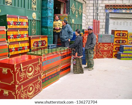 LHASA, TIBET-NOVEMBER 14: locals at a typical Tibetan box shop in Barkhor Street. The ancient street is a symbol of Lhasa and a must see place for visitors. November 14, 2004 in Lhasa, Tibet