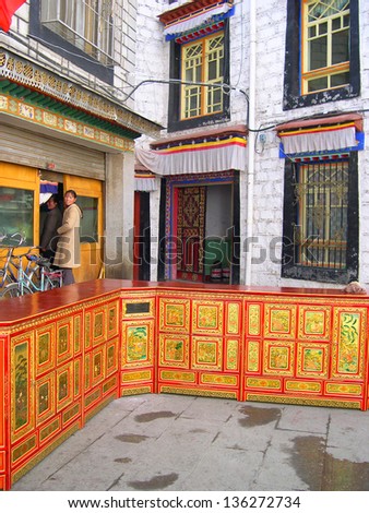LHASA, TIBET-NOVEMBER 14: locals visiting Tibetan furniture shop in Barkhor Street area. The ancient street is a symbol of Lhasa and a must see place for visitors. November 14, 2004 in Lhasa, Tibet