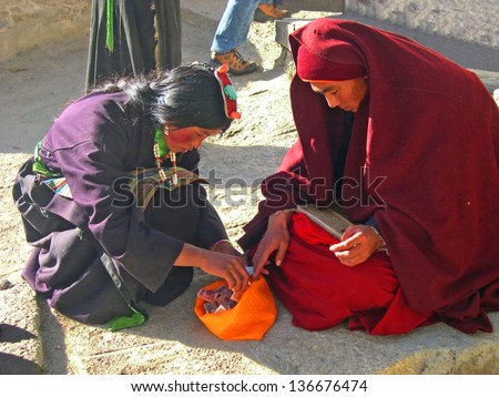 LHASA, TIBET-NOVEMBER 12: monks collecting money in Drepung temple area. The temple houses about 700 monks and attracts over 1 million visitors each year.  November 12, 2004 in Lhasa, Tibet