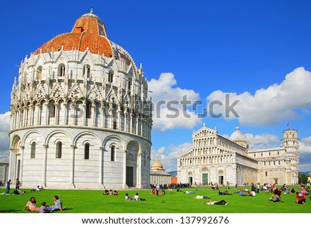 PISA, ITALY-MAY 5: Tourists relaxing in the square of Miracles or Cathedral Square. Up to 4, 5 million tourists a year visit this UNESCO World Heritage site. May 5, 2012 in Pisa, Italy