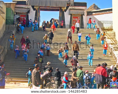 SHIGATSE, TIBET-NOVEMBER 16: children exit from a local school. This is a typical example of Shigatse architecture. November 16, 2004 Shigatse, Tibet