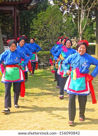 LUZHI, SHANGHAI, CHINA Ã¢Â?Â? OCTOBER 30: ladies performing  dance for tourists. The ancient village is a Shanghai tourist attraction with 100000 visitors per year. October 30, 2004 Luzhi, China.