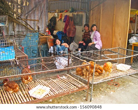 LUZHI, SHANGHAI, CHINA Ã¢Â?Â? OCTOBER 30: girls selling alive chickens. The ancient village is a Shanghai tourist attraction with 100000 visitors per year. October 30, 2004 Luzhi, China.