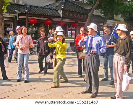 LUZHI, SHANGHAI, CHINA -Â?Â? OCTOBER 30: Tourists start the village visit. The ancient village is a Shanghai tourist attraction with 100000 visitors per year. October 30, 2004 Luzhi, China.