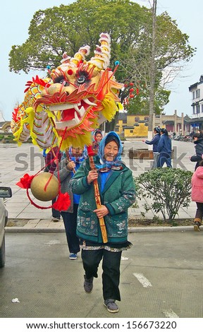 JINXI, SHANGHAI, CHINA Ã¢Â?Â? FEBRUARY 6: local ladies performing the dragon dance. The ancient village is a Shanghai tourist attraction with 100000 visitors per year. February 6, 2005, Jinxi, China