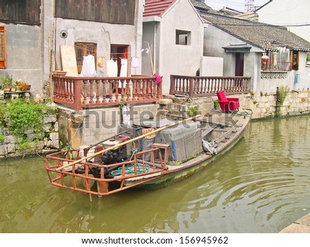 FENGJING, SHANGHAI, CHINA  SEPTEMBER 19: boat along a village canal. The ancient village is a Shanghai tourist attraction with 100000 visitors per year. September 19, 2004, Fengjing, China