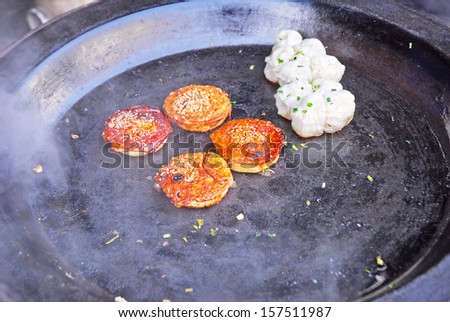 JINXI, SHANGHAI, CHINA Ã¢Â?Â? JANUARY 9: Chinese food cooking in a village street. The ancient village is a Shanghai tourist attraction with 100000 visitors per year. January 9, 2010, Jinxi, China
