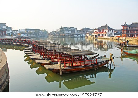 JINXI, SHANGHAI, CHINA  JANUARY 9: boats for tourist at the village main entry. The ancient village is a Shanghai tourist attraction with 100000 visitors per year. January 9, 2010, Jinxi, China