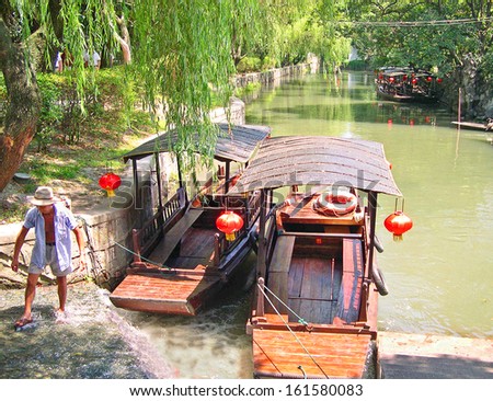 NANXUN, SHANGHAI, CHINA Ã¢Â?Â? AUGUST 28: man attending boats for tourists. The Nanxun water village is Shanghai tourist attraction with 100000 visitors year. August 28, 2004,Nanxun, China