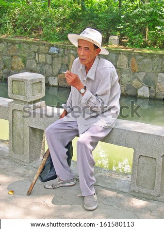 NANXUN, SHANGHAI, CHINA Ã¢Â?Â? AUGUST 28: man relaxing near a village canal. The water village is Shanghai tourist attraction with 100000 visitors year. August 28, 2004,Nanxun, China