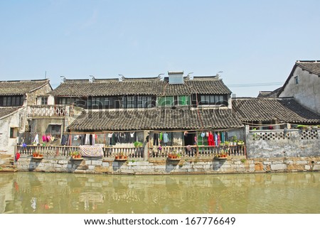 FENGJING, SHANGHAI, CHINA -Â?Â? MARCH 17: old houses along the main waterway. The ancient village is a Shanghai tourist attraction with 100000 visitors per year. March 17, 2010, Fengjing, China