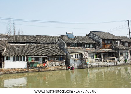 FENGJING, SHANGHAI, CHINA - MARCH 17: old houses along the main waterway. The ancient village is a Shanghai tourist attraction with 100000 visitors per year. March 17, 2010, Fengjing, China