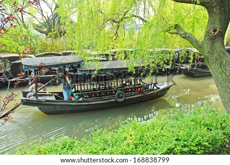NANXUN, SHANGHAI, CHINA - APRIL 11: Lady running a tourists boat. The Nanxun water town is Shanghai tourist attraction with 100000 visitors year. April 11, 2007,Nanxun, China