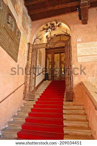 RAVENNA, ITALY- MARCH 20, 2014: old city council building entrance in People square. The city defined by UNESCO heritage of humanity has 3 million tourists per year