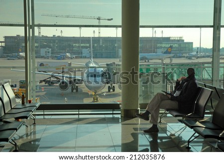 MUNICH, GERMANY-SEPTEMBER 25, 2013: business man at the airport. With 38 millions passengers per year it is one of the most important airport in Europe.