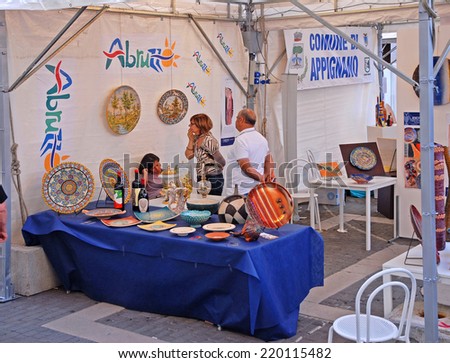 FAENZA, ITALY- SEPTEMBER 7, 2014: items on display and vendor at the ceramic Sunday open market. The market is very popular in the city and attracts thousands of people.