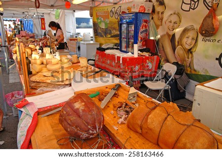 CERVIA, ITALY-SEPTEMBER 21, 2014: roast pig and cheese  stand at the annual International food outdoor market. This market is very popular and attract thousands of tourists.