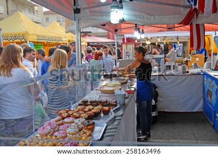 CERVIA, ITALY-SEPTEMBER 21, 2014: cakes stand at the annual International food outdoor market. This market is very popular and attract thousands of tourists.
