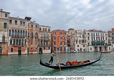 VENICE, ITALY-FEBRUARY 20, 2007: gondolier looking for tourists in the Grand canal.  Venice is a great tourists attraction with more than 27 million tourists every year.