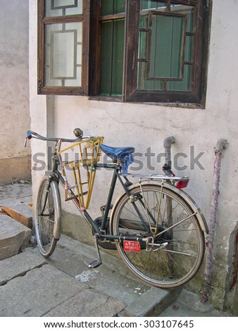 ZHUJIAJIAO, SHANGHAI-AUGUST 8, 2004: bicycle equipped for baby transportation.  Zhujiajiao ancient village is a Shanghai tourist attraction with more than 1000000 visitors per year.
