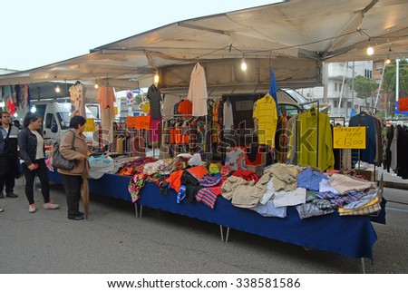 CERVIA, ITALY-MAY 16, 2015: clothing vendor at the Saturday outdoor market. The place is very popular in the city and attracts thousands of people.