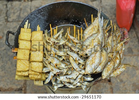 China, Shanghai water village Zhouzhuang street food  fried fishes and tofu.