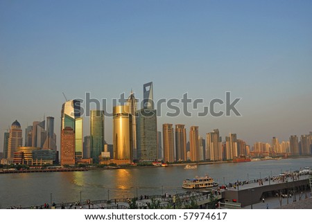 China Shanghai Pudong riverfront buildings at sunset.