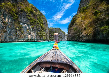 Traditional wooden  boat in a picture perfect tropical bay on Koh Phi Phi Island, Thailand, Asia.