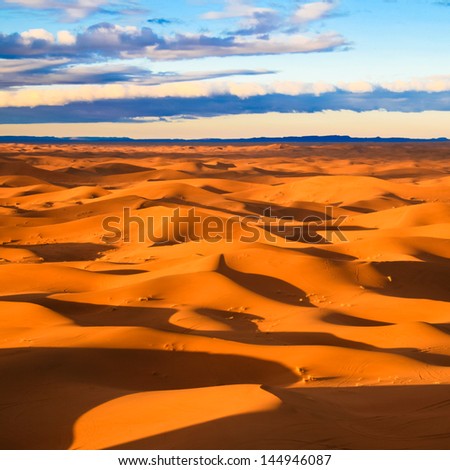 Warm morning light over never ending sand dunes in Morocco.