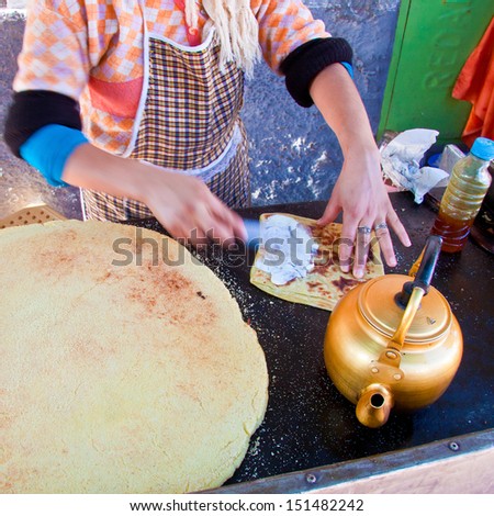 Woman baking delicious moroccan pancakes popular for traditional breakfast.