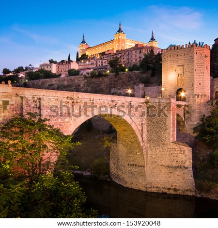 Panorama of the alcazar above the medieval San Martin bridge - Toledo, Madrid, Spain.