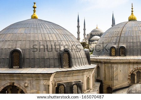 Blue Mosque or Sultan Ahmed Mosque viewed trough the window of Hagia Sophia, former Orthodox patriarchal basilica (church), later a mosque, and now a museum in Istanbul, Turkey.