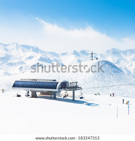 Skiers on ski lift the ski slopes in  Alp mountains, Triglav natural park, Vogel, Bohinj, Slovenia.
