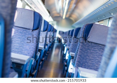 Modern european economy class fast train interior. Inside of high speed train compartment.