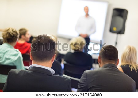 Speaker at business workshop and presentation. Audience at the conference room.