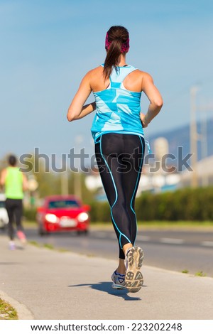 Young female runner.  Running woman. Female Runner Jogging during Outdoor Workout. Beautiful fit Girl. Fitness model outdoors. Weight Loss. Healthy lifestyle.